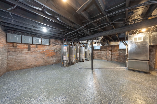 basement featuring gas water heater, brick wall, and heating unit