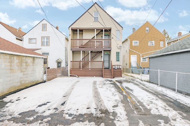 rear view of property featuring a balcony