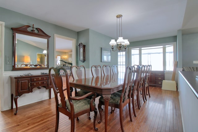 dining area with a chandelier and light wood-type flooring