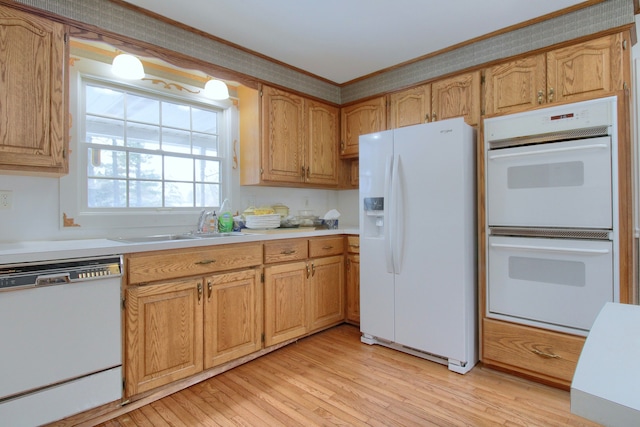 kitchen with sink, white appliances, and light wood-type flooring