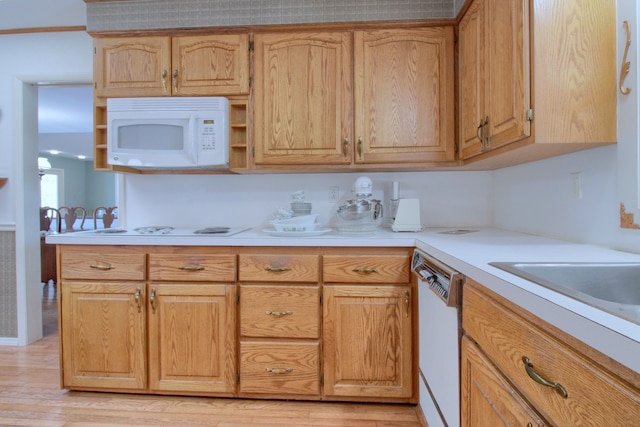 kitchen featuring white appliances and light hardwood / wood-style floors