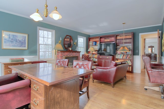 office area with light hardwood / wood-style flooring, a notable chandelier, crown molding, and a fireplace