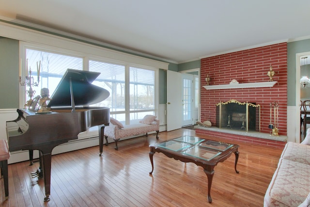 living room featuring hardwood / wood-style flooring, ornamental molding, and a fireplace