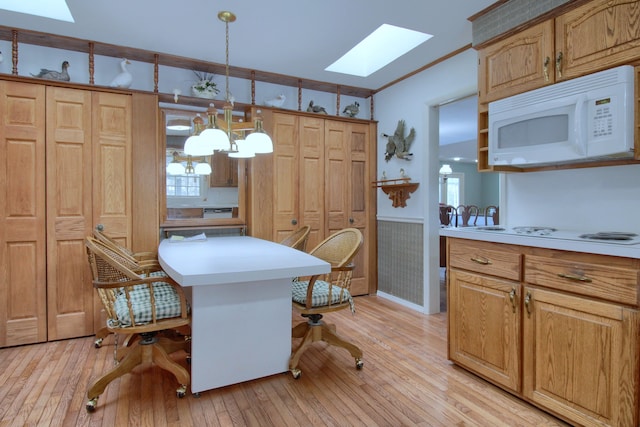 interior space featuring a skylight, ornamental molding, plenty of natural light, and light wood-type flooring