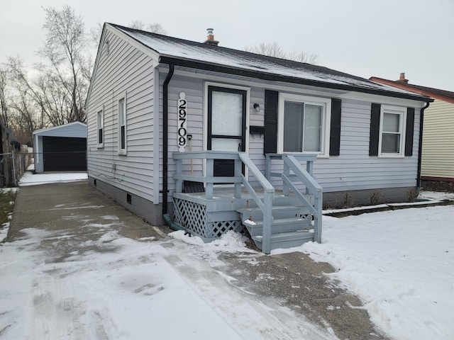 view of front of home featuring a garage and an outdoor structure