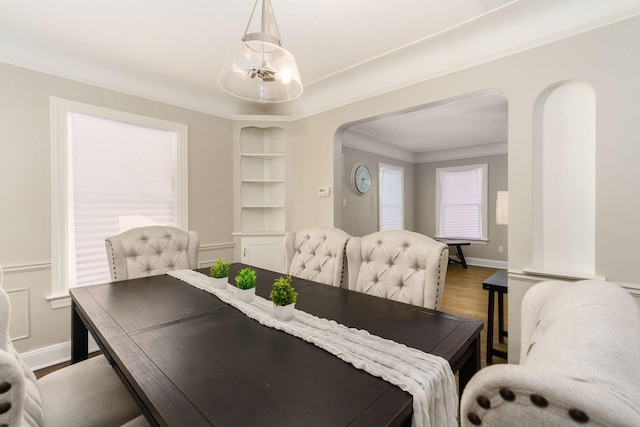 dining room featuring ornamental molding and hardwood / wood-style floors