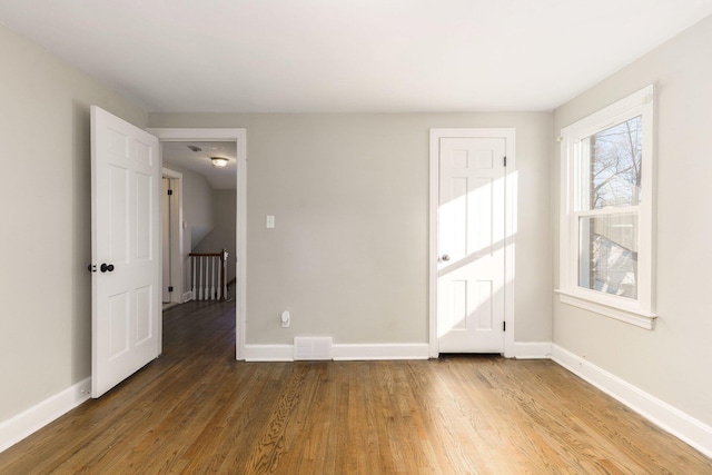 spare room featuring dark hardwood / wood-style floors