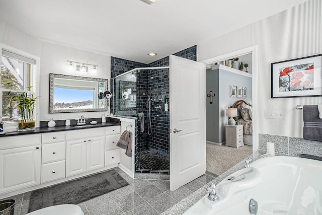 full bath with a stall shower, a garden tub, and vanity