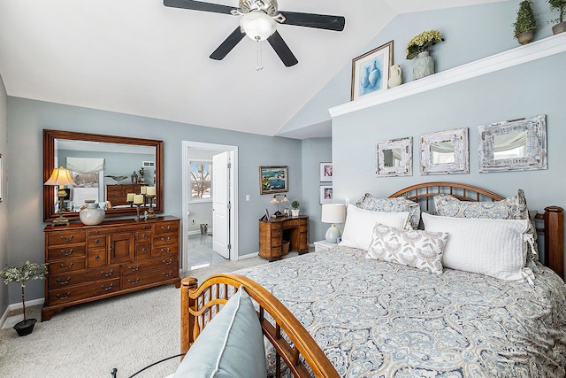 bedroom with baseboards, ceiling fan, ensuite bathroom, carpet floors, and high vaulted ceiling