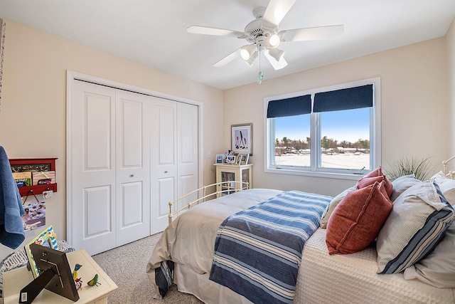 bedroom with carpet floors, a closet, and a ceiling fan