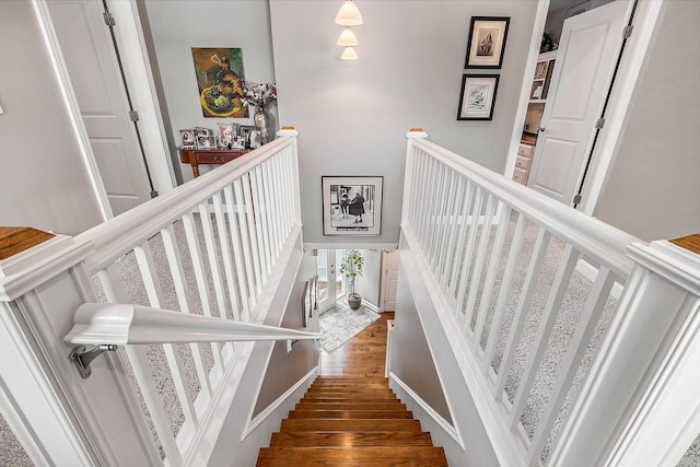 stairs featuring wood finished floors and baseboards