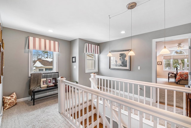 hall with recessed lighting, carpet, an upstairs landing, and baseboards