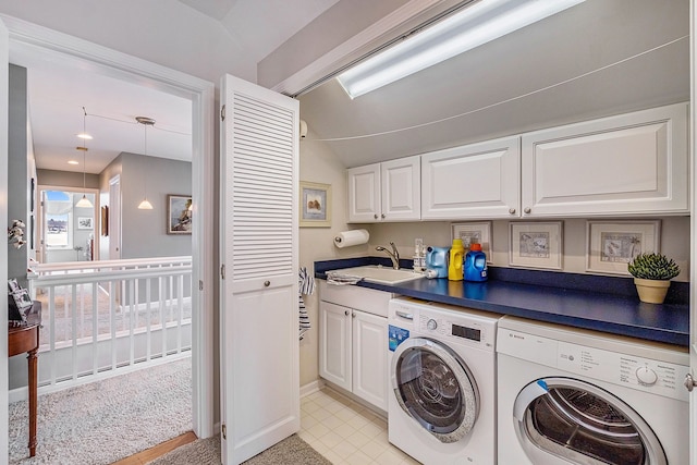 washroom with laundry area, a sink, and washer and dryer