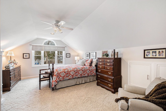 bedroom featuring baseboards, vaulted ceiling, a ceiling fan, and light colored carpet