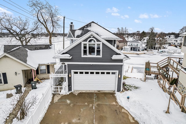 view of front of property featuring a garage and a chimney