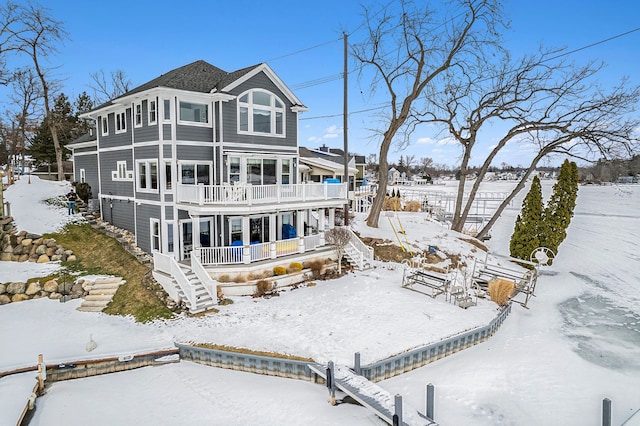 view of snow covered rear of property