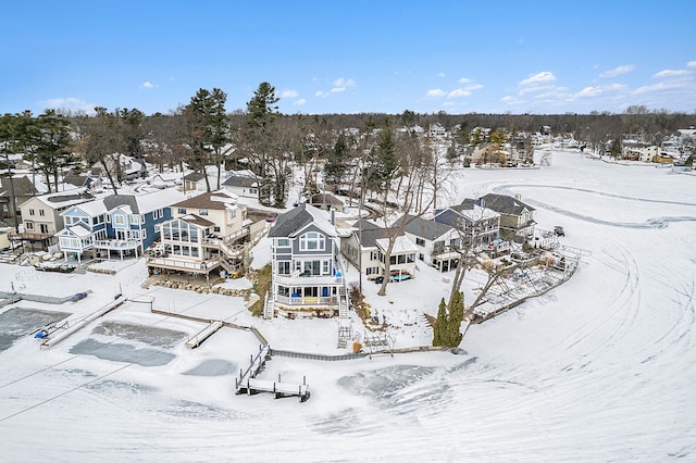 snowy aerial view with a residential view