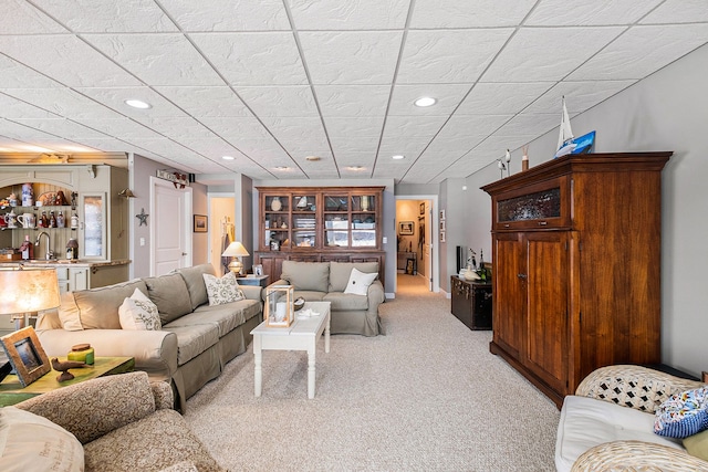 living room with light carpet and recessed lighting