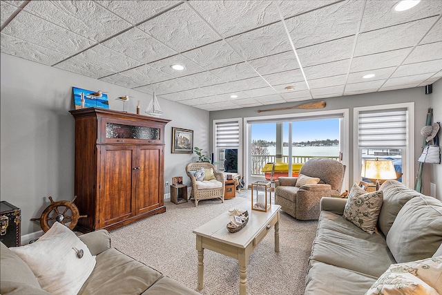 carpeted living room featuring baseboards and recessed lighting