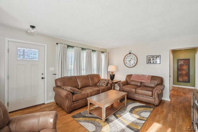 living room with light hardwood / wood-style flooring and a textured ceiling