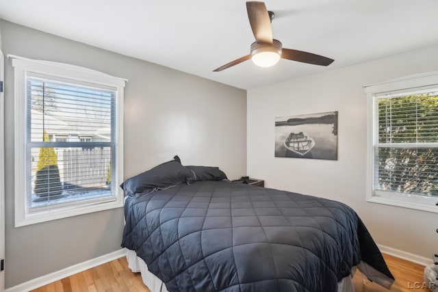 bedroom with hardwood / wood-style flooring and ceiling fan