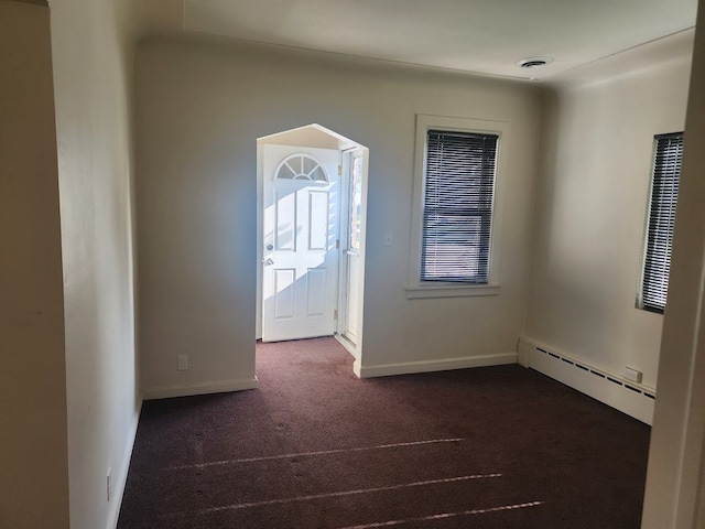 carpeted entrance foyer featuring baseboard heating