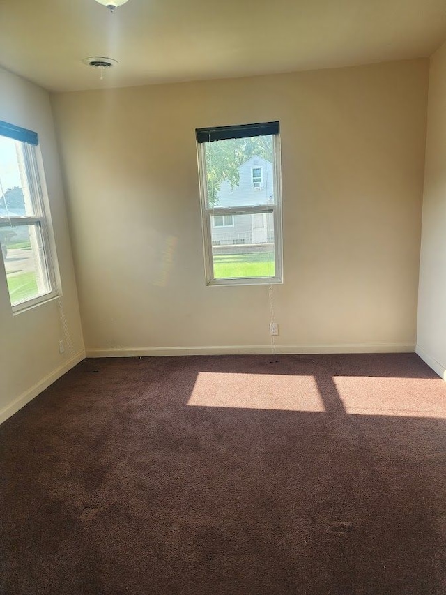 empty room with dark colored carpet