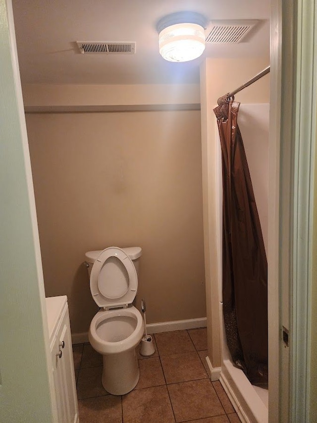 bathroom with tile patterned flooring, vanity, a shower with shower curtain, and toilet