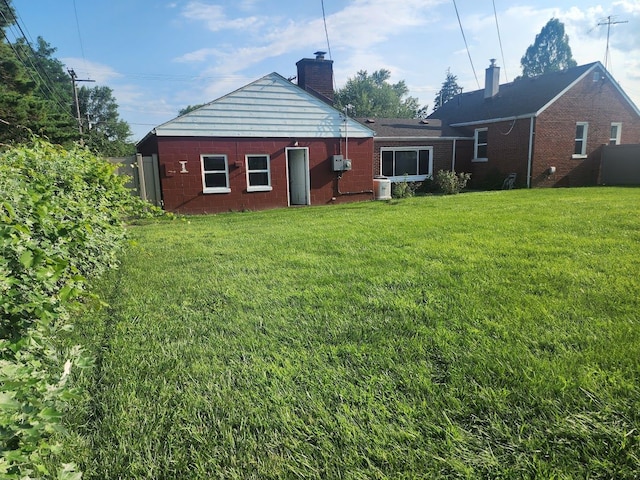 back of house with a lawn