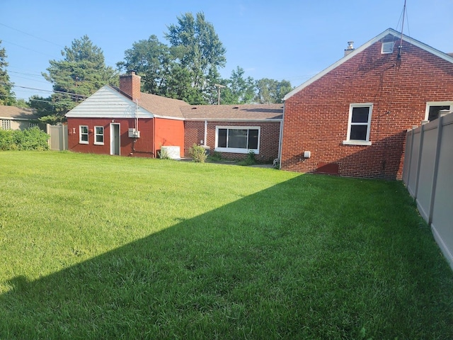 back of house featuring a lawn