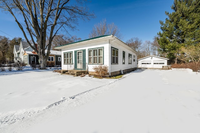 view of front of property with a garage and an outdoor structure