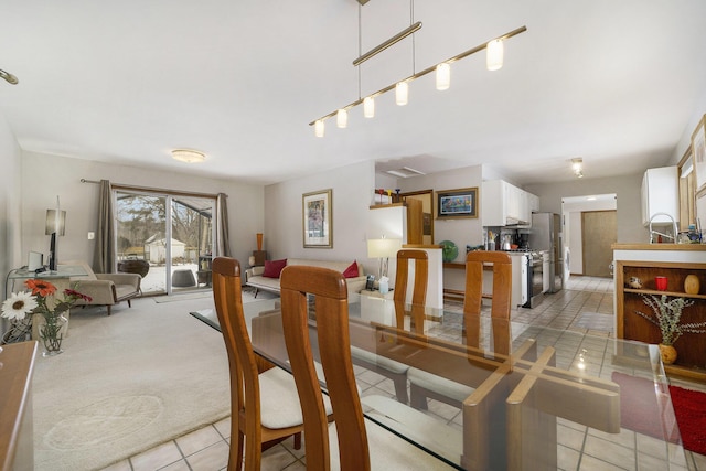 dining space with light tile patterned floors and sink