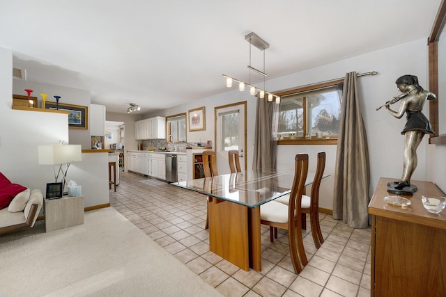 carpeted dining room with sink