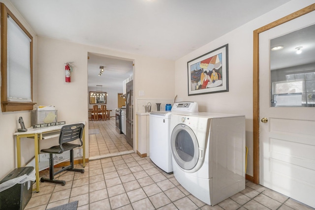 laundry room featuring light tile patterned flooring and washer and clothes dryer