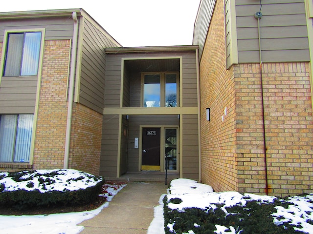 view of snow covered property entrance