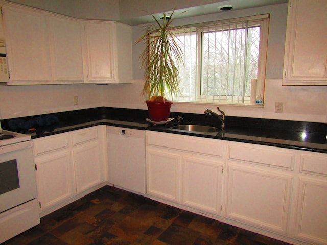 kitchen featuring white cabinetry, sink, and white appliances