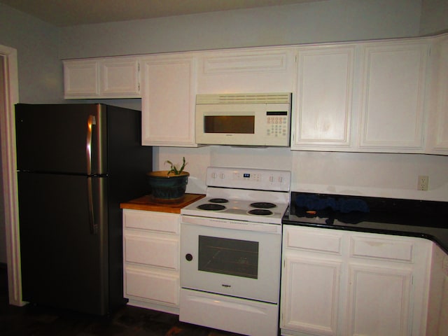 kitchen featuring white cabinetry and white appliances