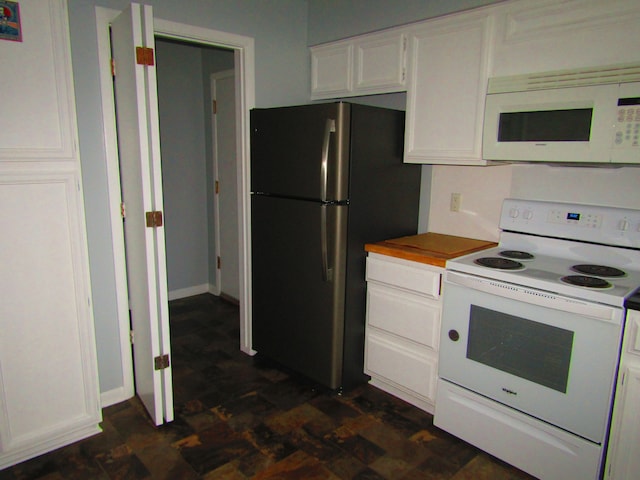 kitchen with white cabinetry, wood counters, and white appliances