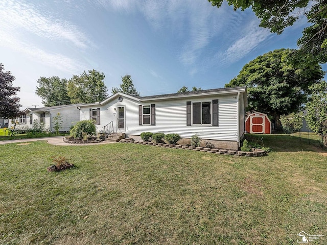 view of front of house with a front yard and a storage unit