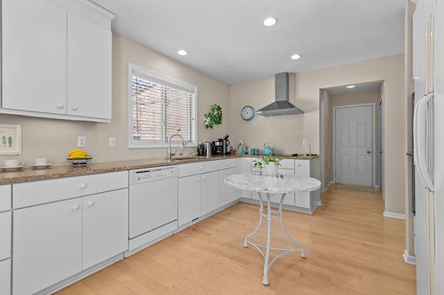 kitchen with white cabinetry, white appliances, and wall chimney exhaust hood