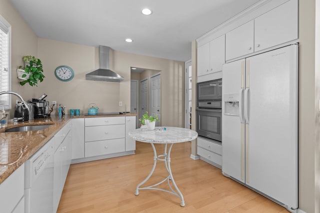 kitchen with white cabinetry, sink, wall chimney exhaust hood, and black appliances