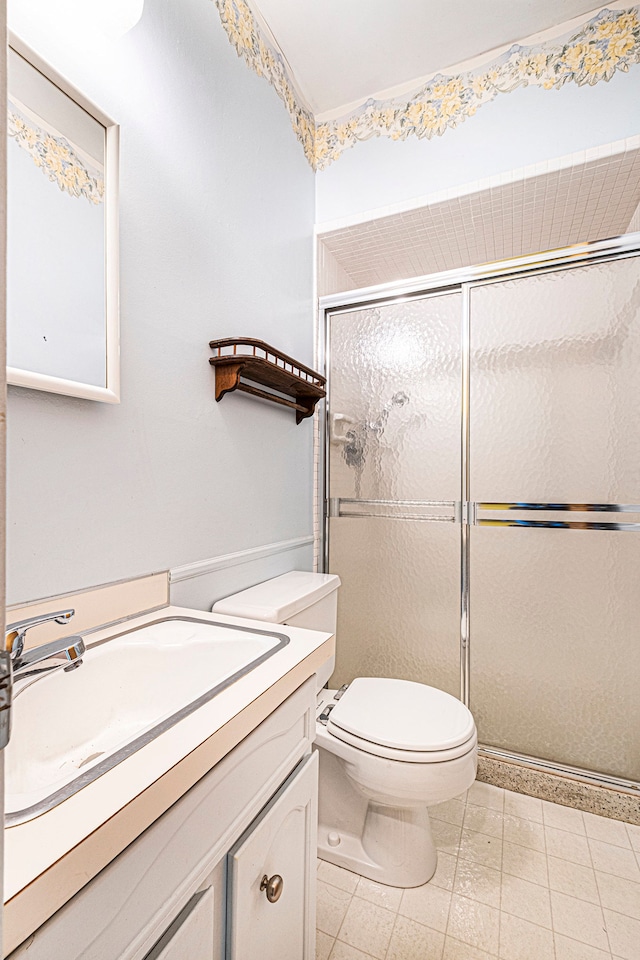 bathroom featuring toilet, vanity, and walk in shower