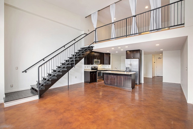 unfurnished living room with a high ceiling