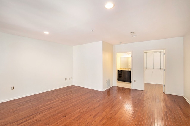 unfurnished living room featuring wood-type flooring