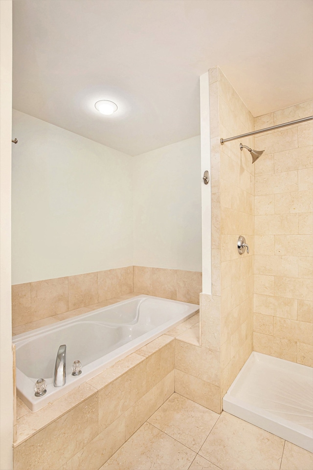 bathroom with tile patterned flooring and a tile shower