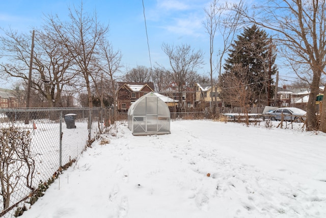 yard covered in snow featuring an outdoor structure