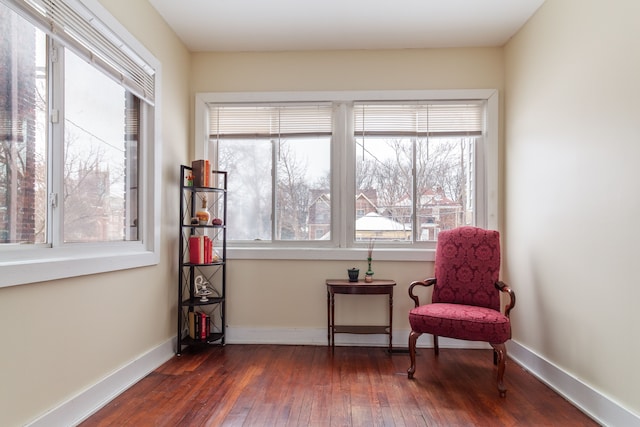 sitting room with dark wood-type flooring