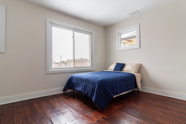 bedroom with dark wood-type flooring