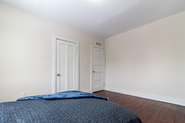 bedroom featuring dark hardwood / wood-style flooring