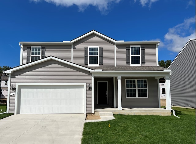 front facade with a garage, a front yard, and covered porch